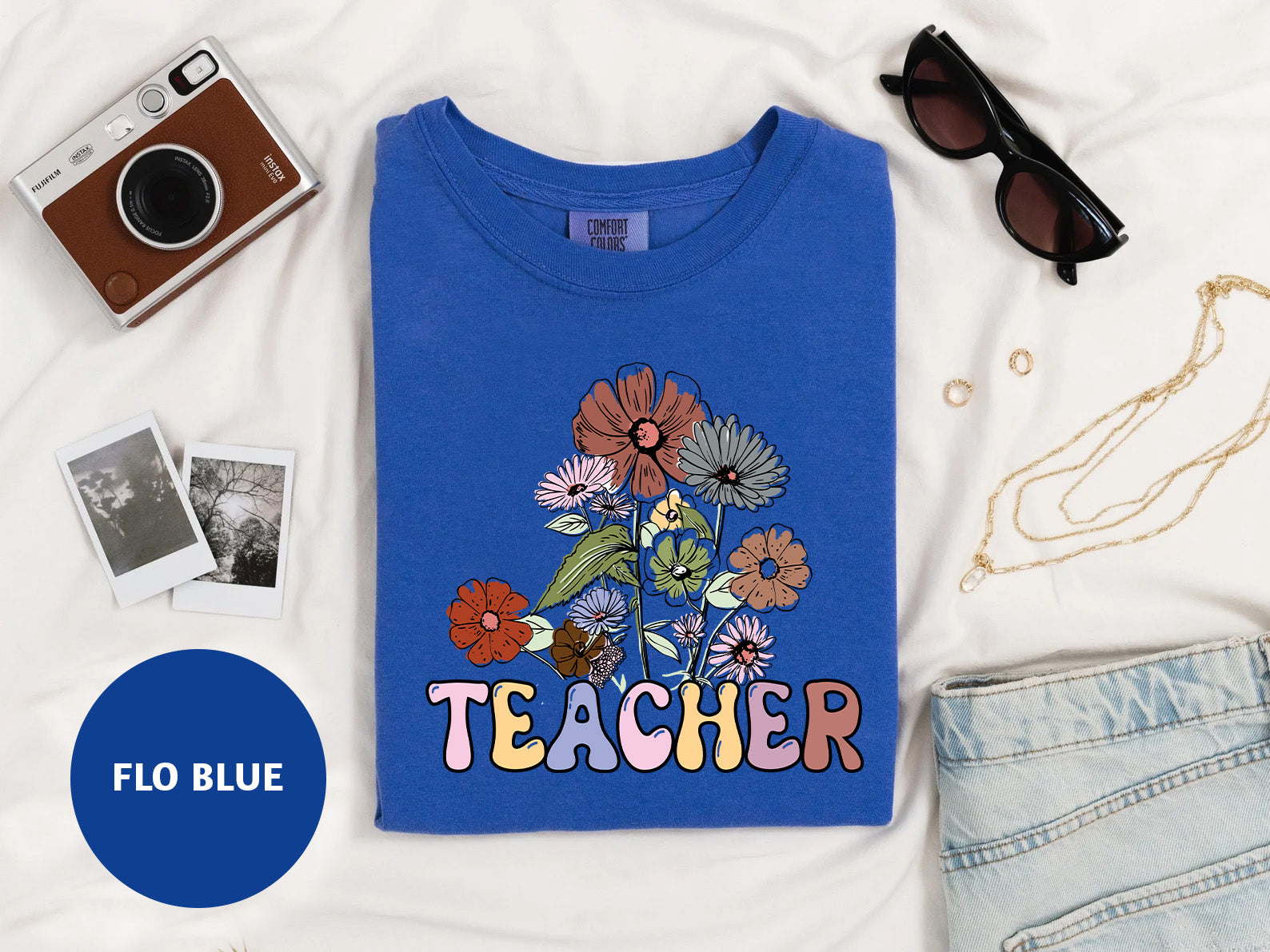 a t - shirt with a picture of a flower and the words teacher on it