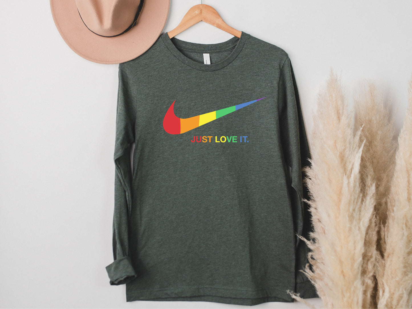 a t - shirt hanging on a wall next to a hat