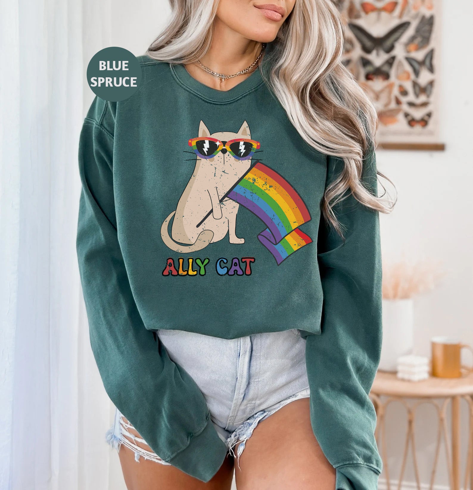 a woman wearing a green sweatshirt with a cat on it