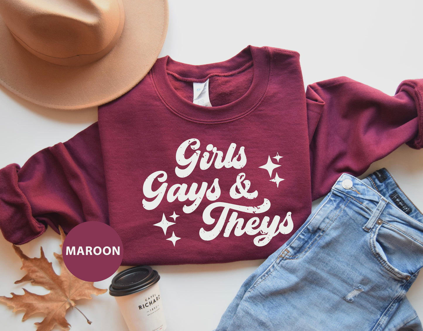 a maroon shirt that says girls, gays and they's next to a