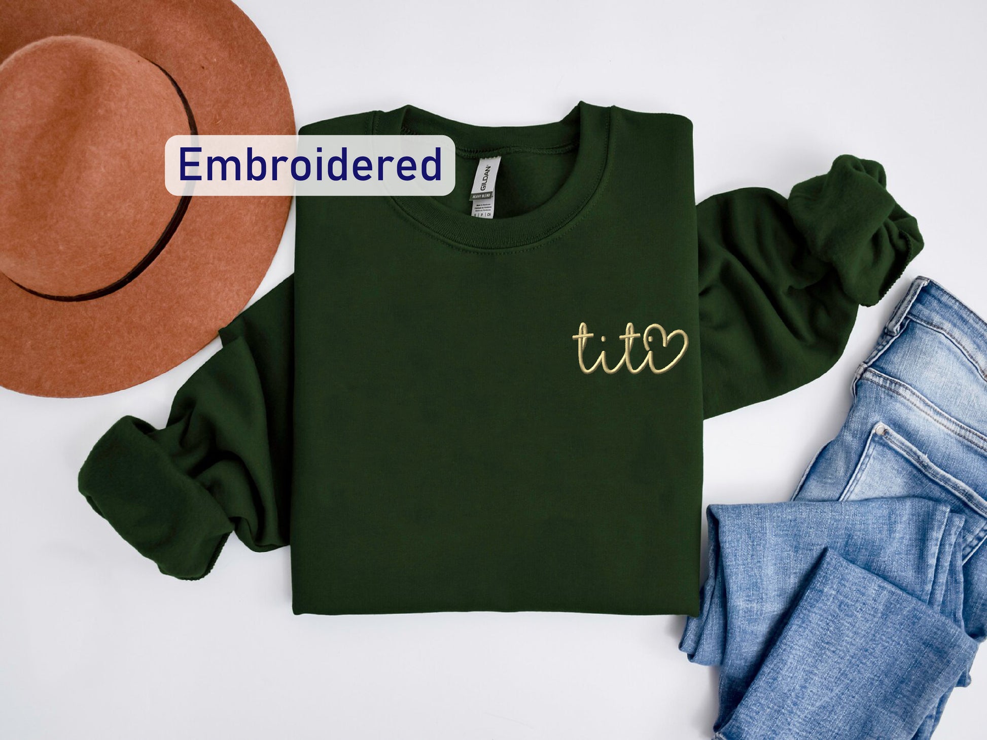 a hat, jeans, and a t - shirt on a white surface