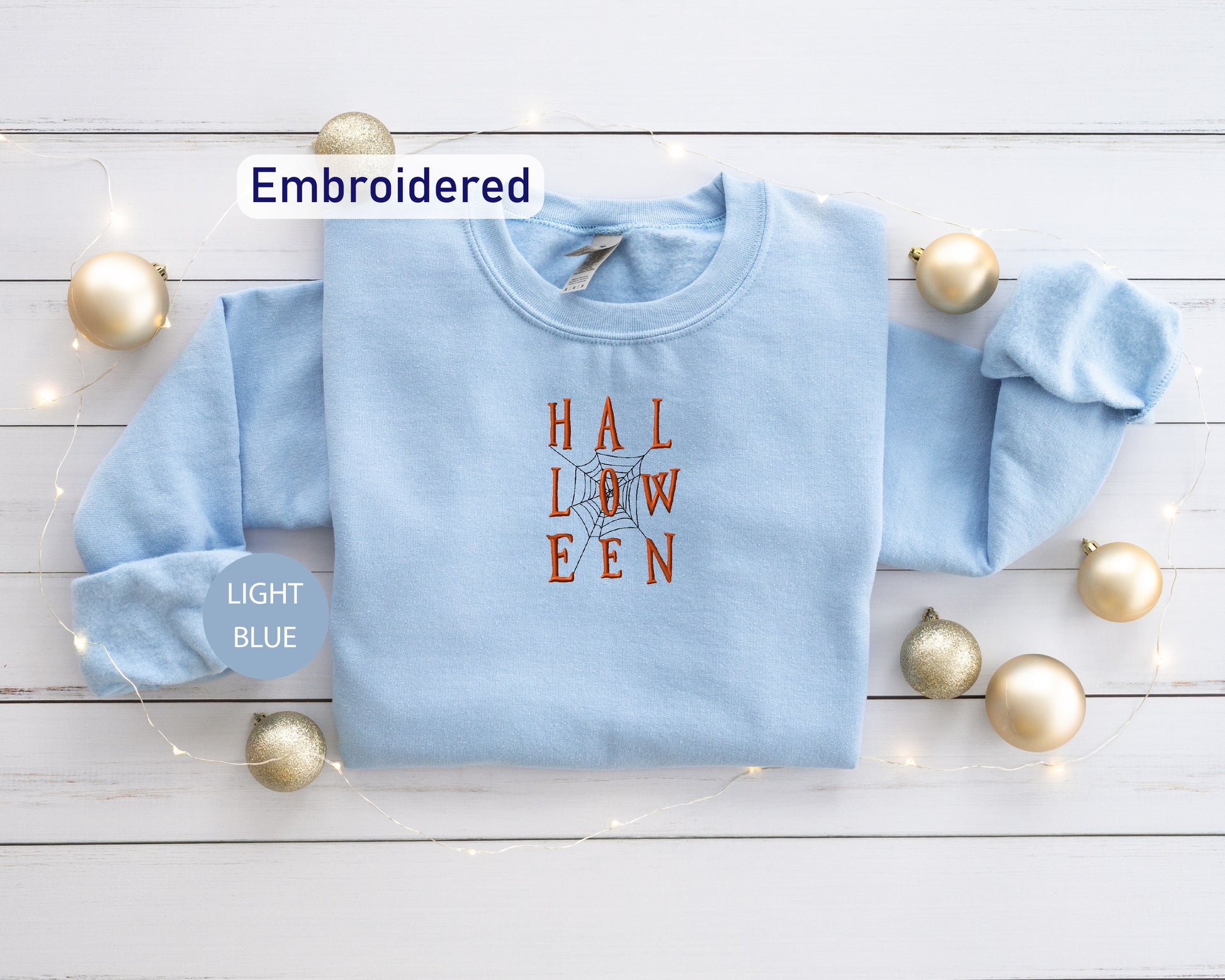 a light blue sweater with the words hall down on it