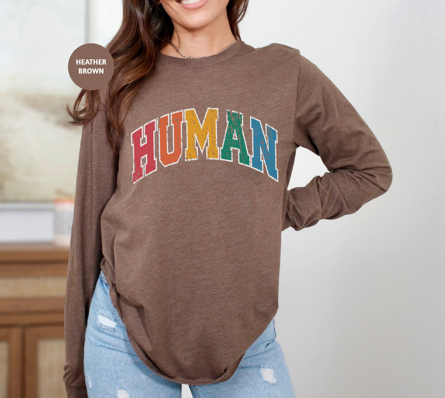 a woman wearing a brown shirt with the word human on it