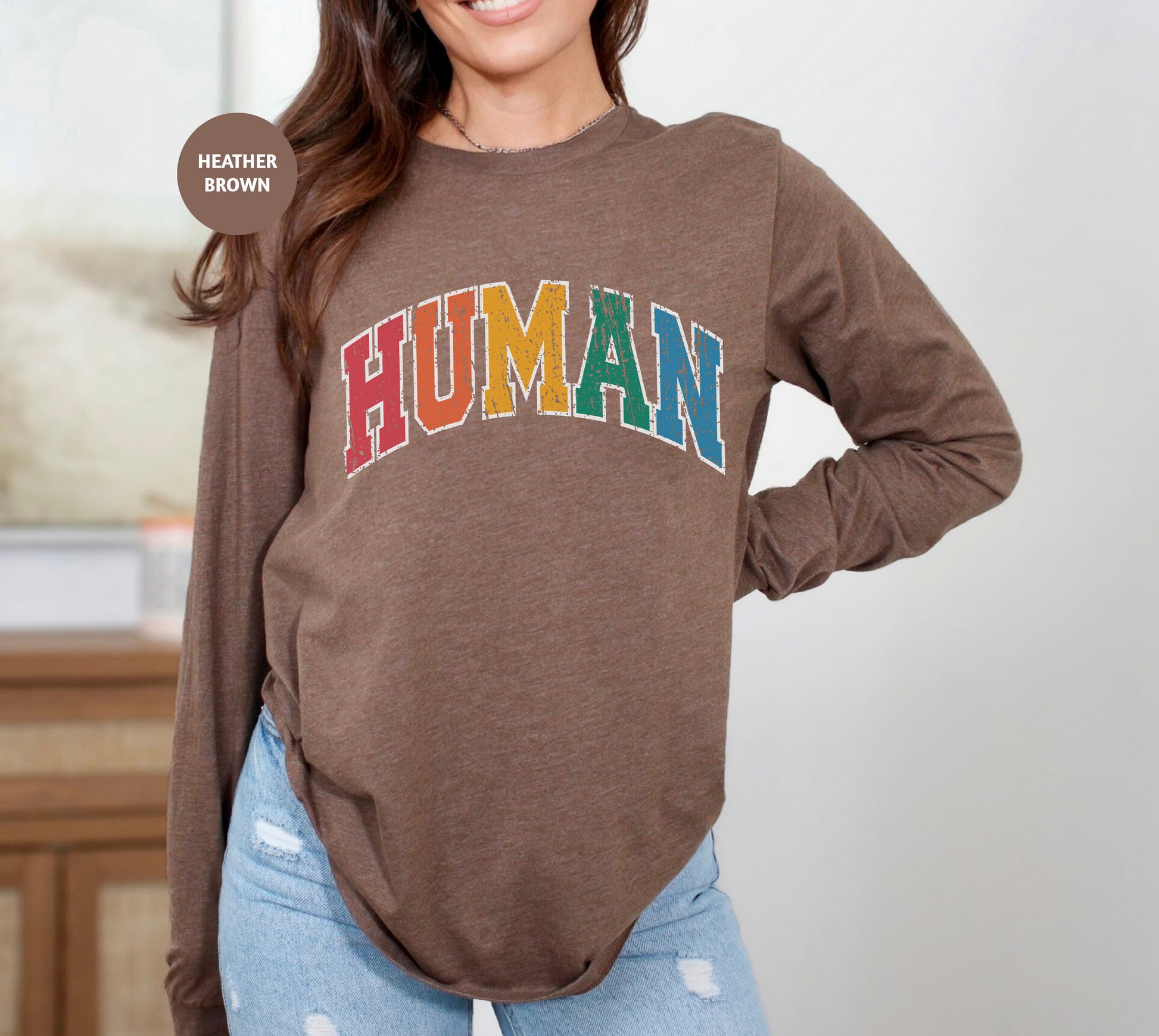 a woman wearing a brown shirt with the word human on it