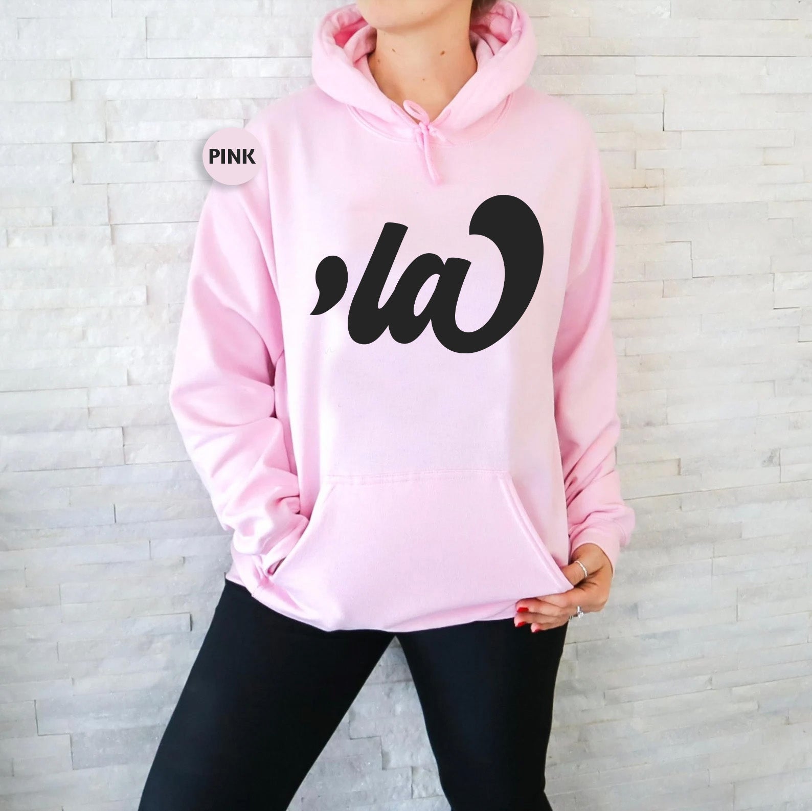 a woman wearing a pink hoodie with the word pink on it