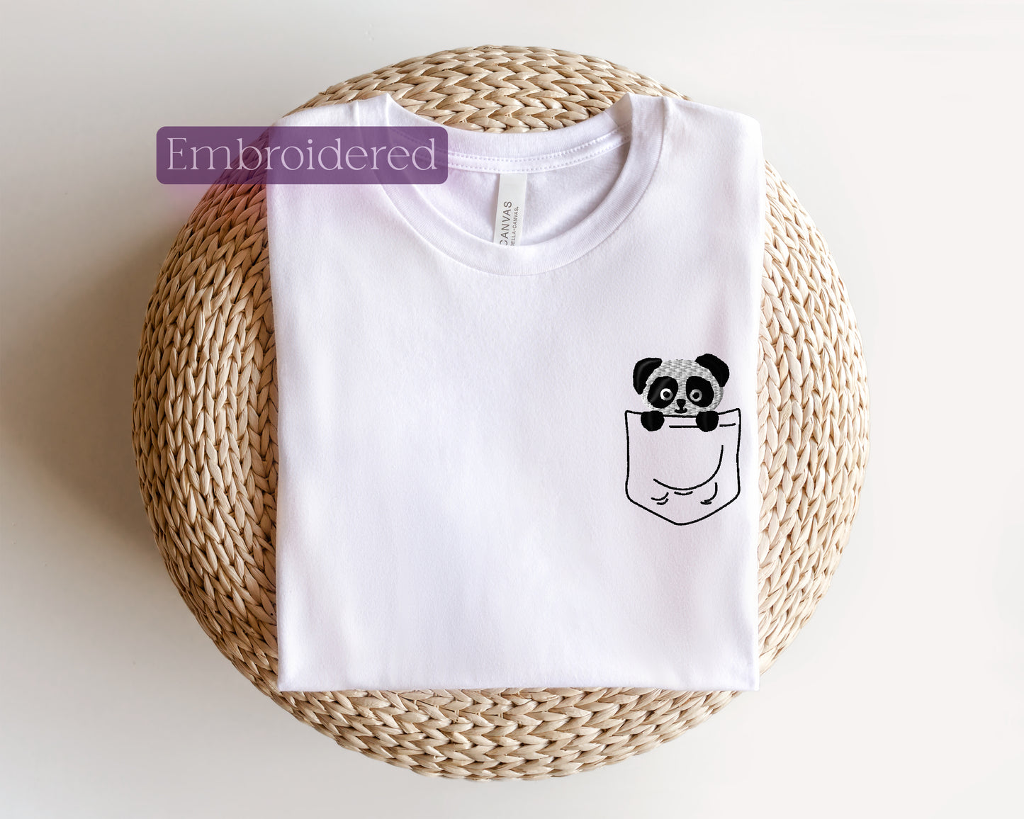 a white t - shirt with a panda in a pocket