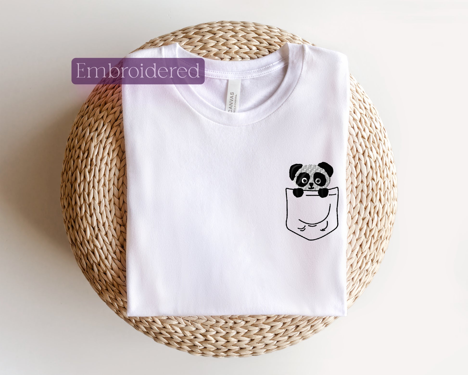 a white t - shirt with a panda in a pocket