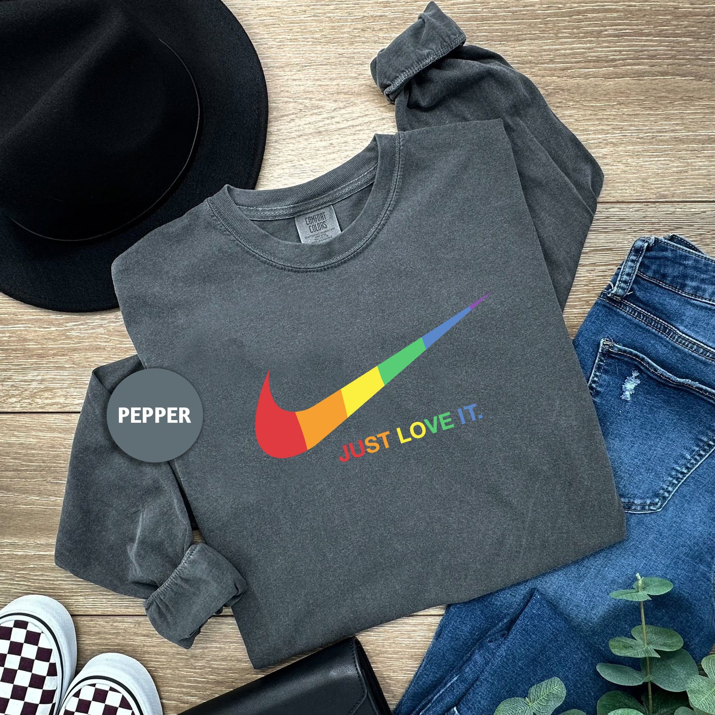 a pair of jeans, a hat, and a t - shirt on a wooden