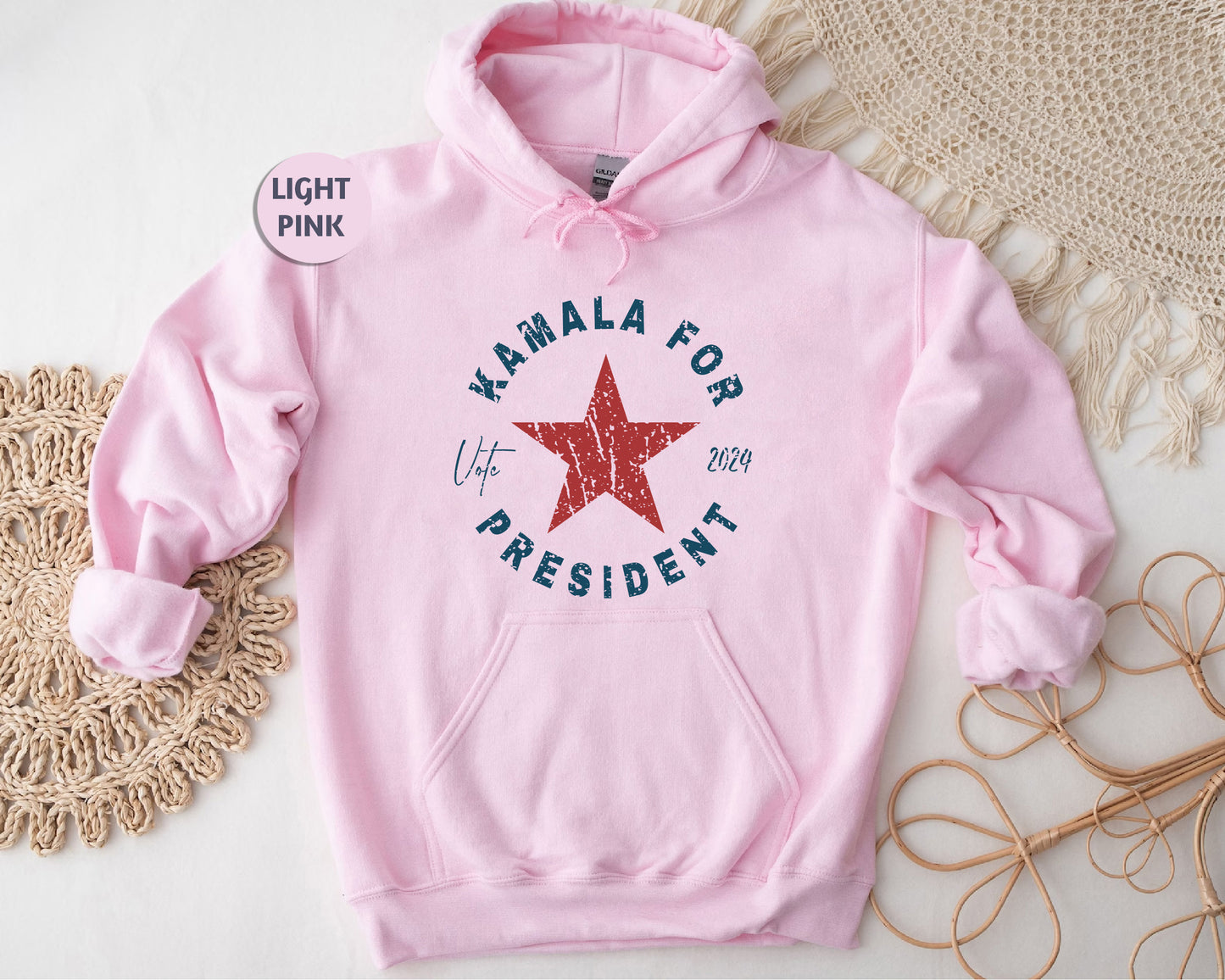 a pink hoodie with a red star on it