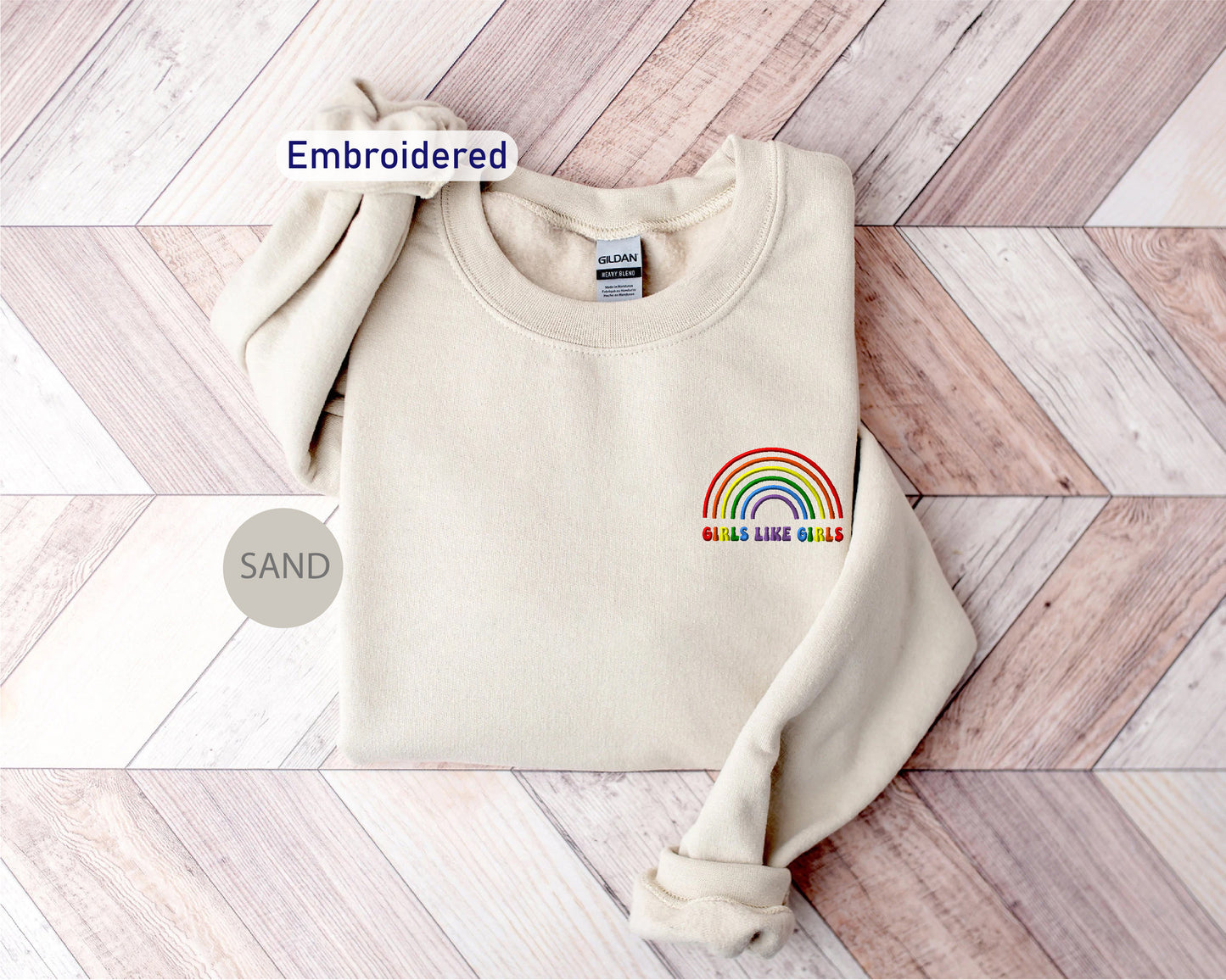 a white sweater with a rainbow embroidered on it