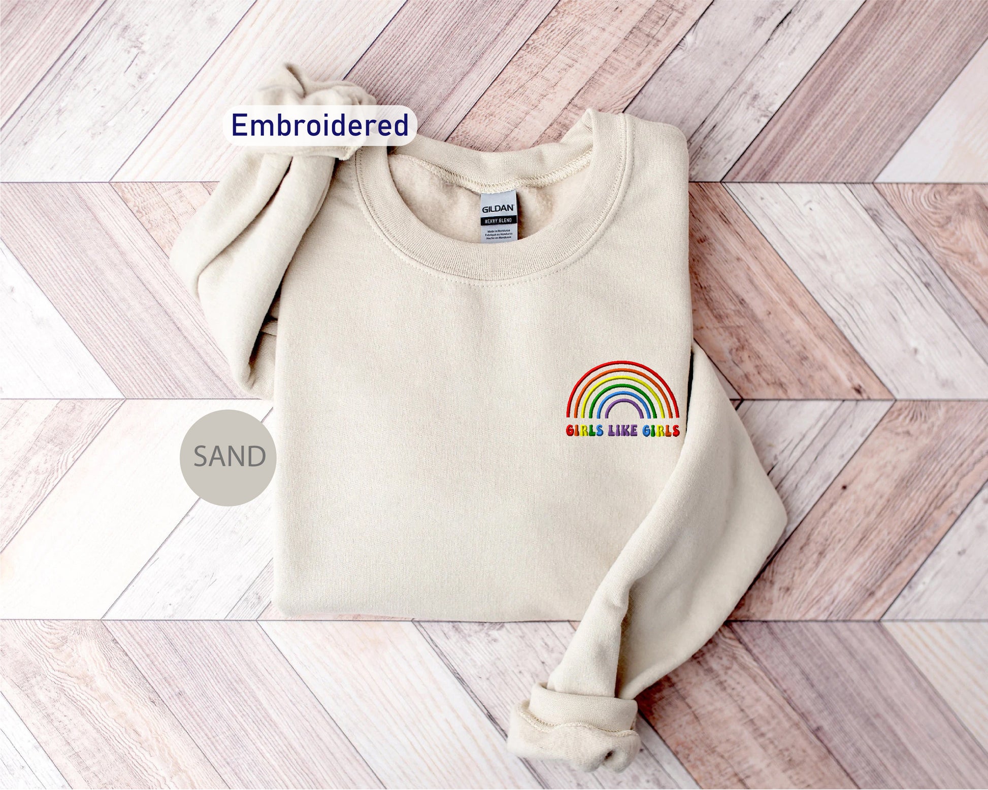 a white sweater with a rainbow embroidered on it