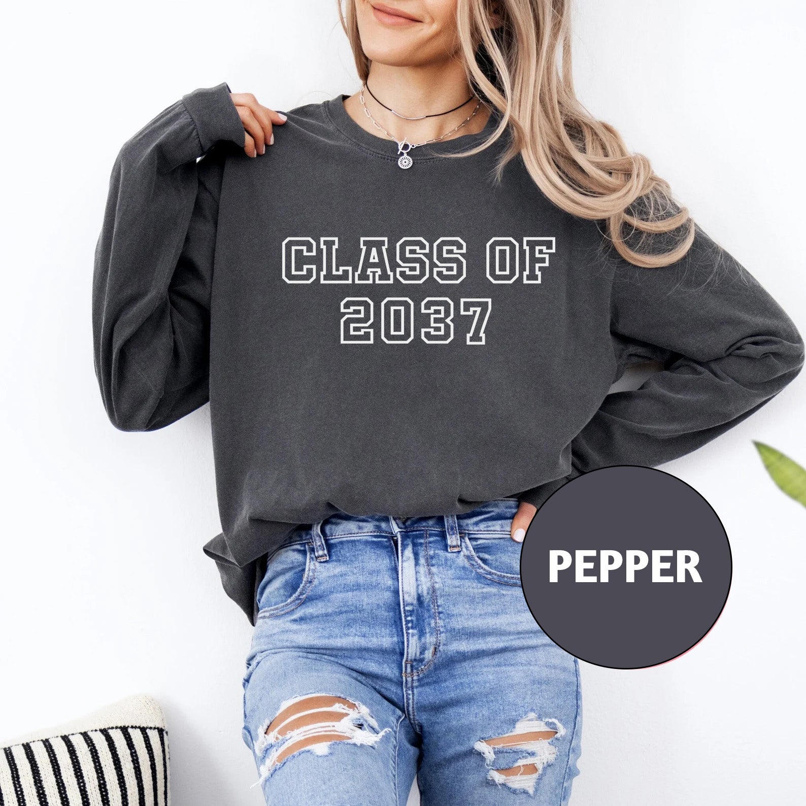 a woman wearing a black sweatshirt with the words class of 202 printed on it