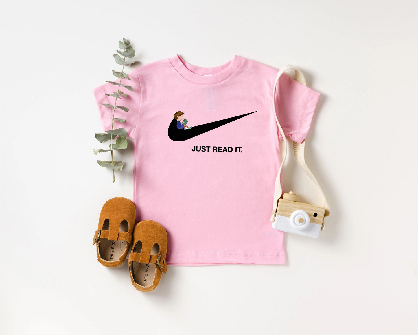 a pink shirt with a picture of a person on it and a pair of shoes
