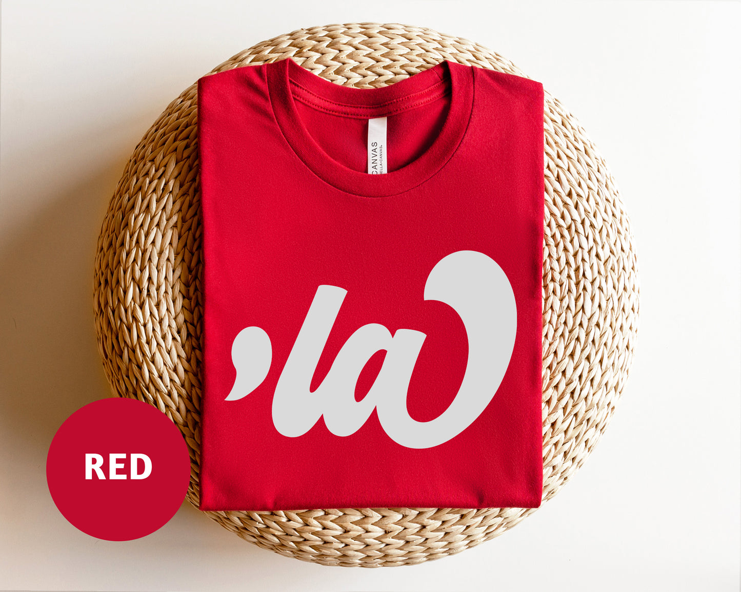 a red t - shirt with the word la on it