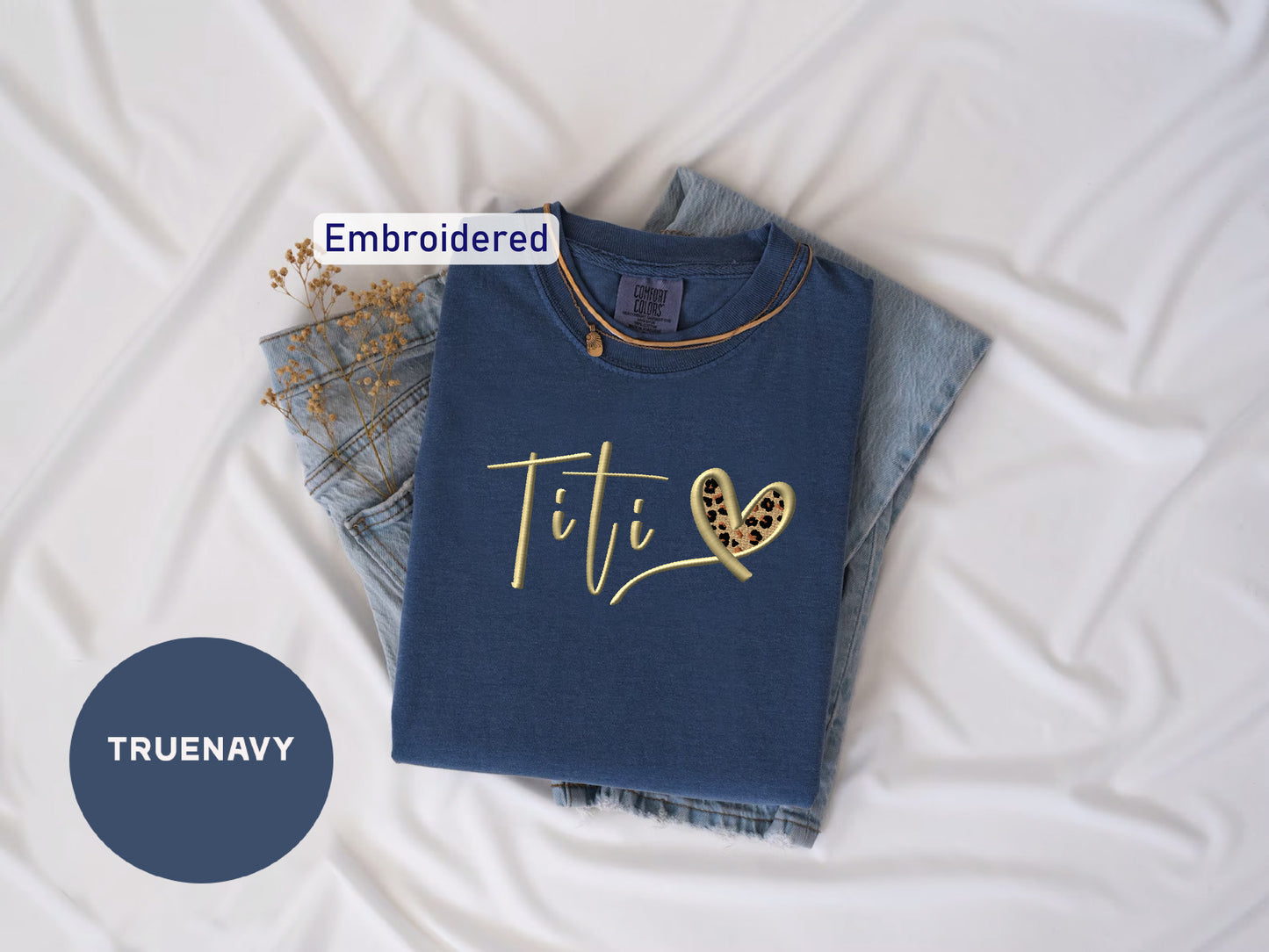 a t - shirt with the word tit on it next to a pair of