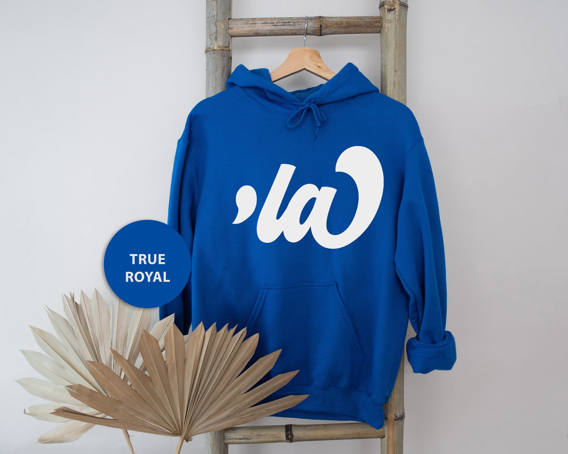 a blue hoodie sitting on top of a wooden chair