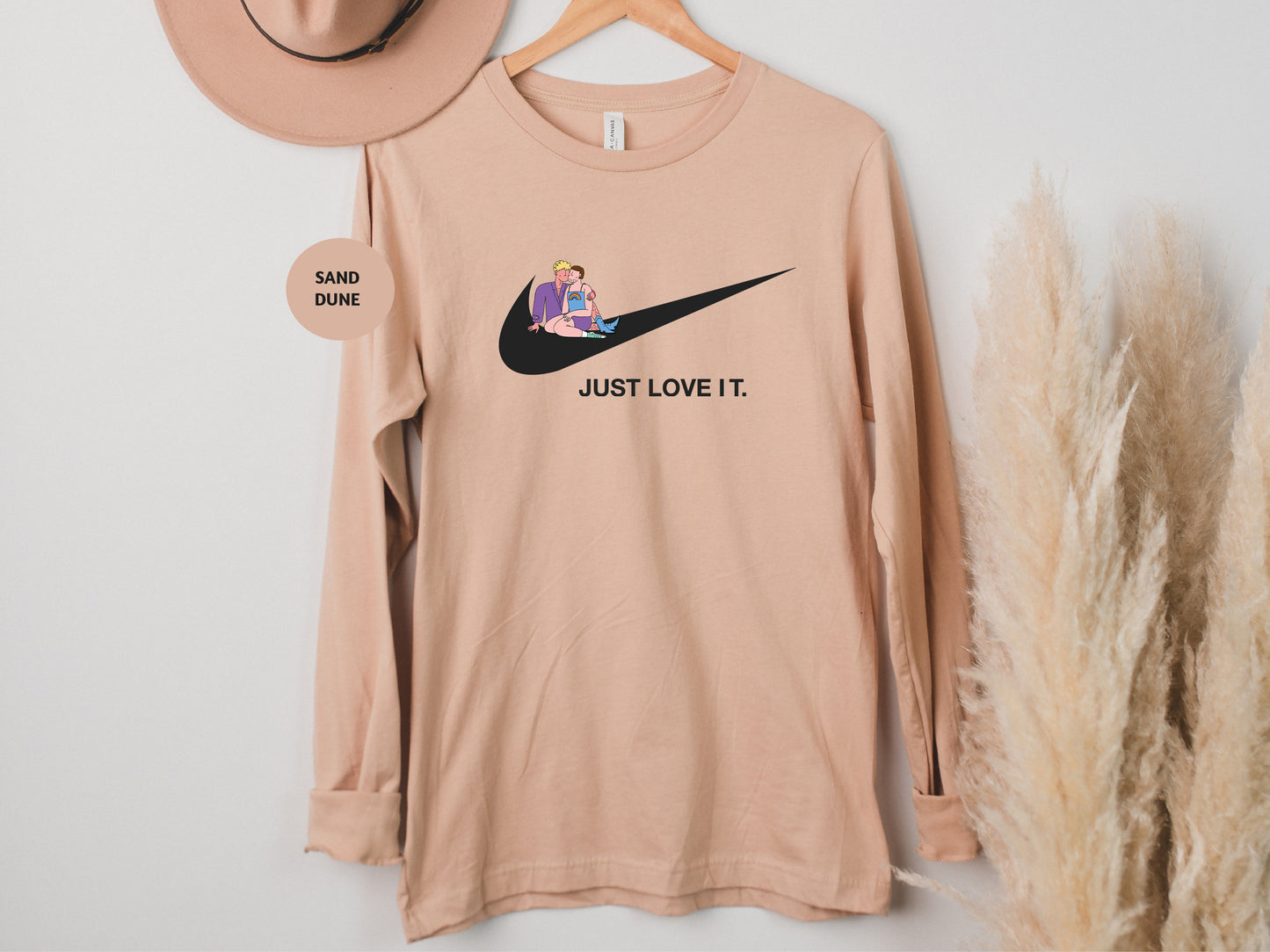 a t - shirt that says just love it and a hat hanging on a wall