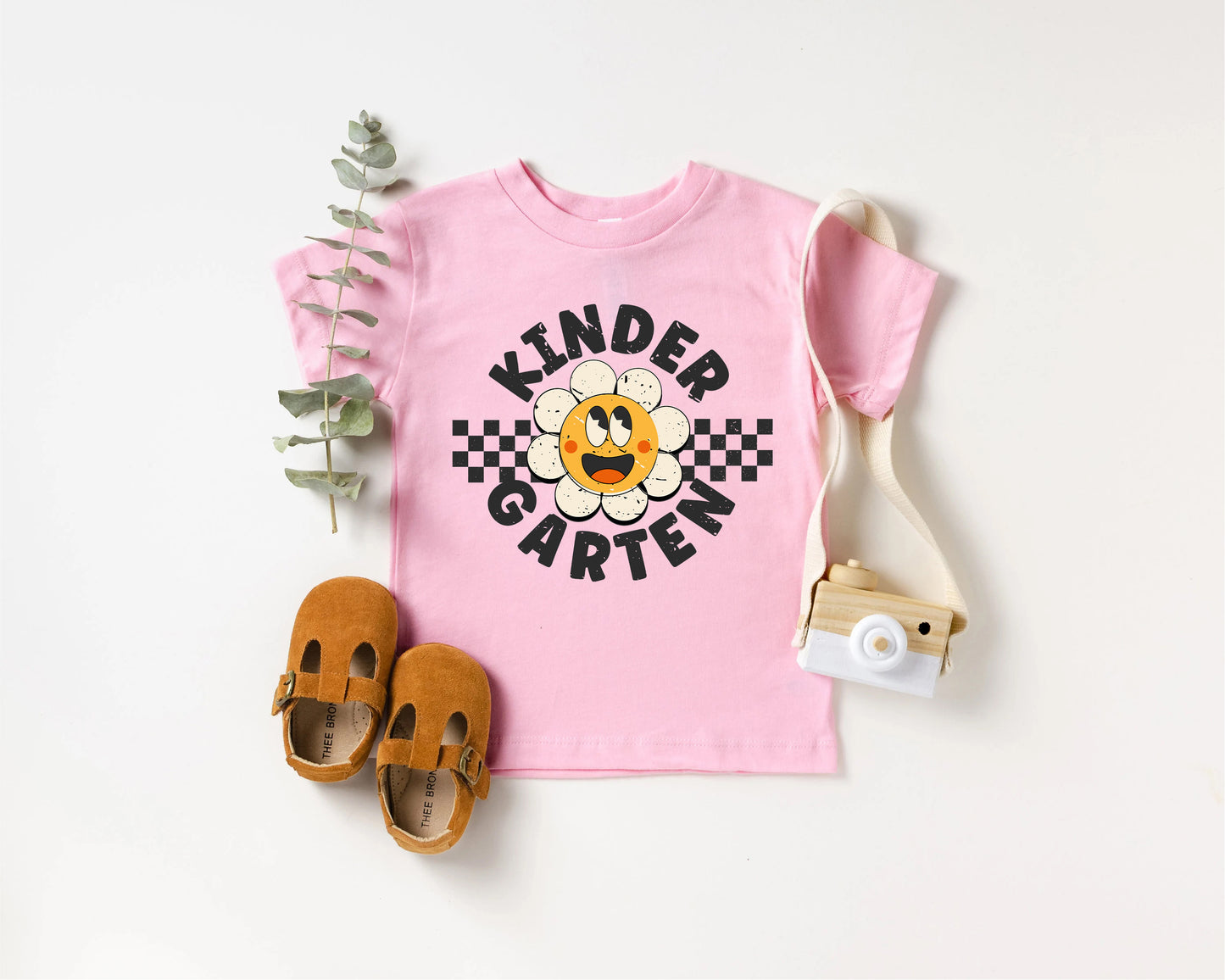 a pink shirt with a picture of a cartoon character on it and a pair of