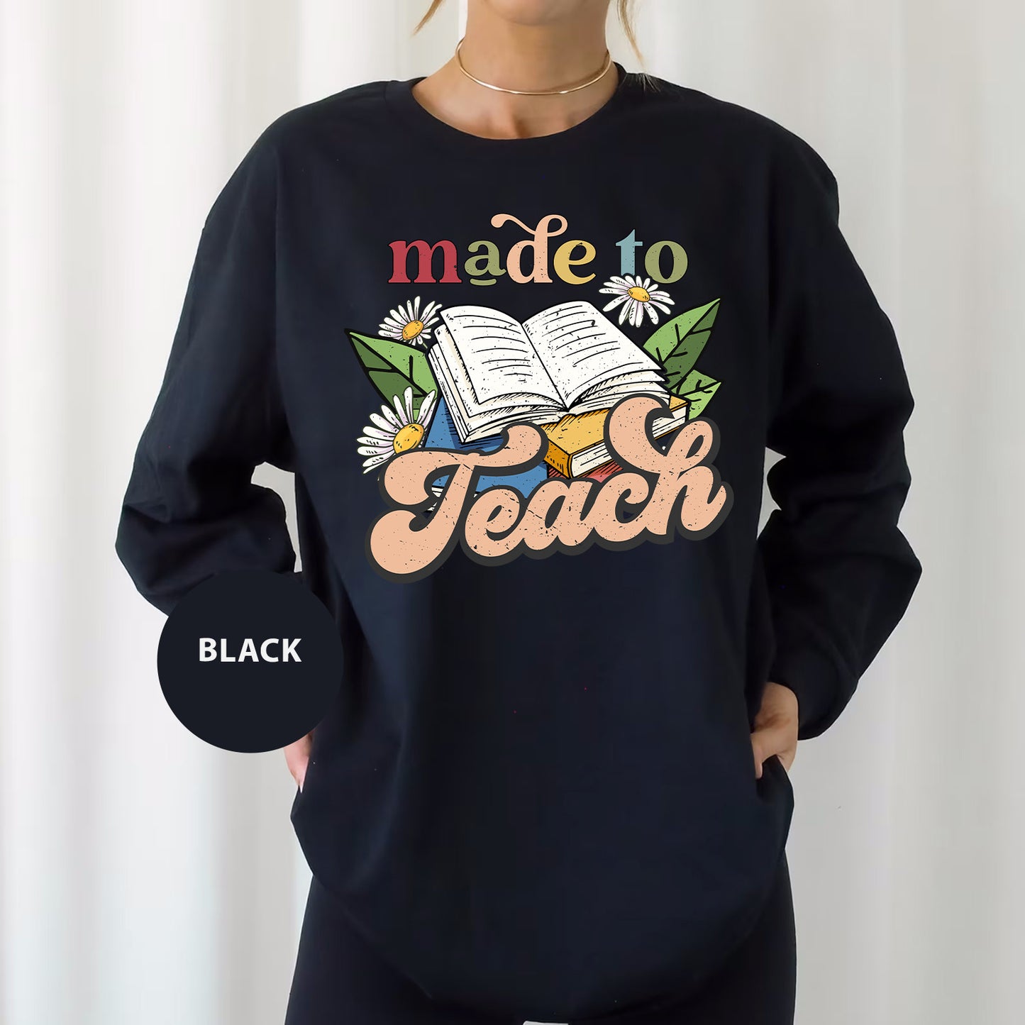 a woman wearing a sweatshirt that says made to teach