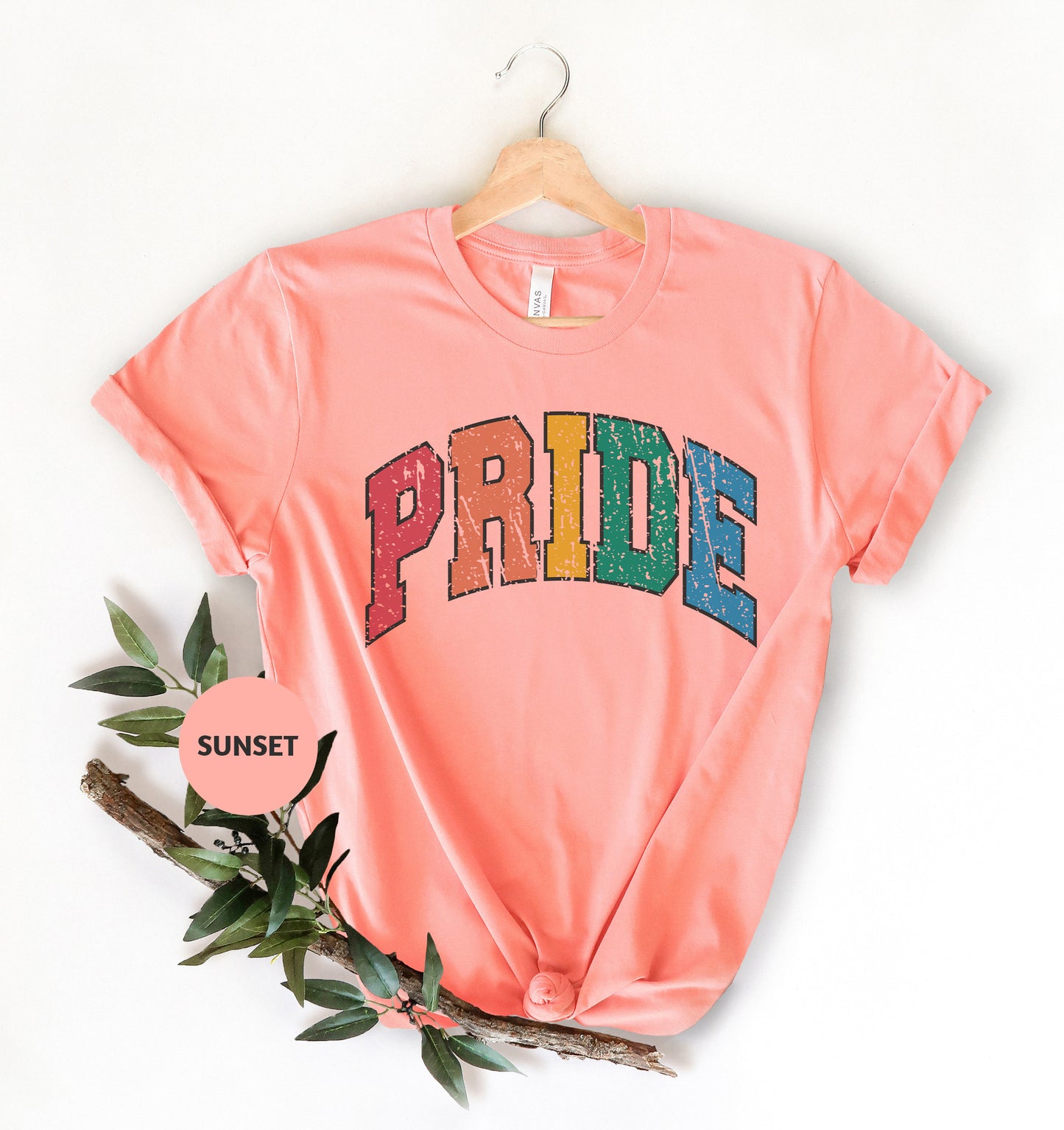 a pink shirt with the word pride printed on it
