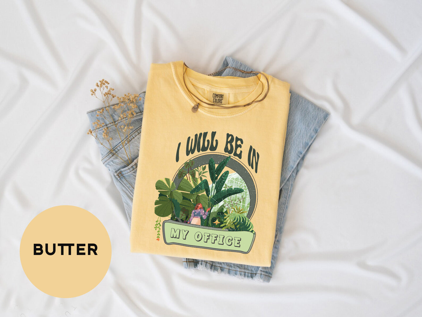 a yellow shirt with a picture of a plant on it
