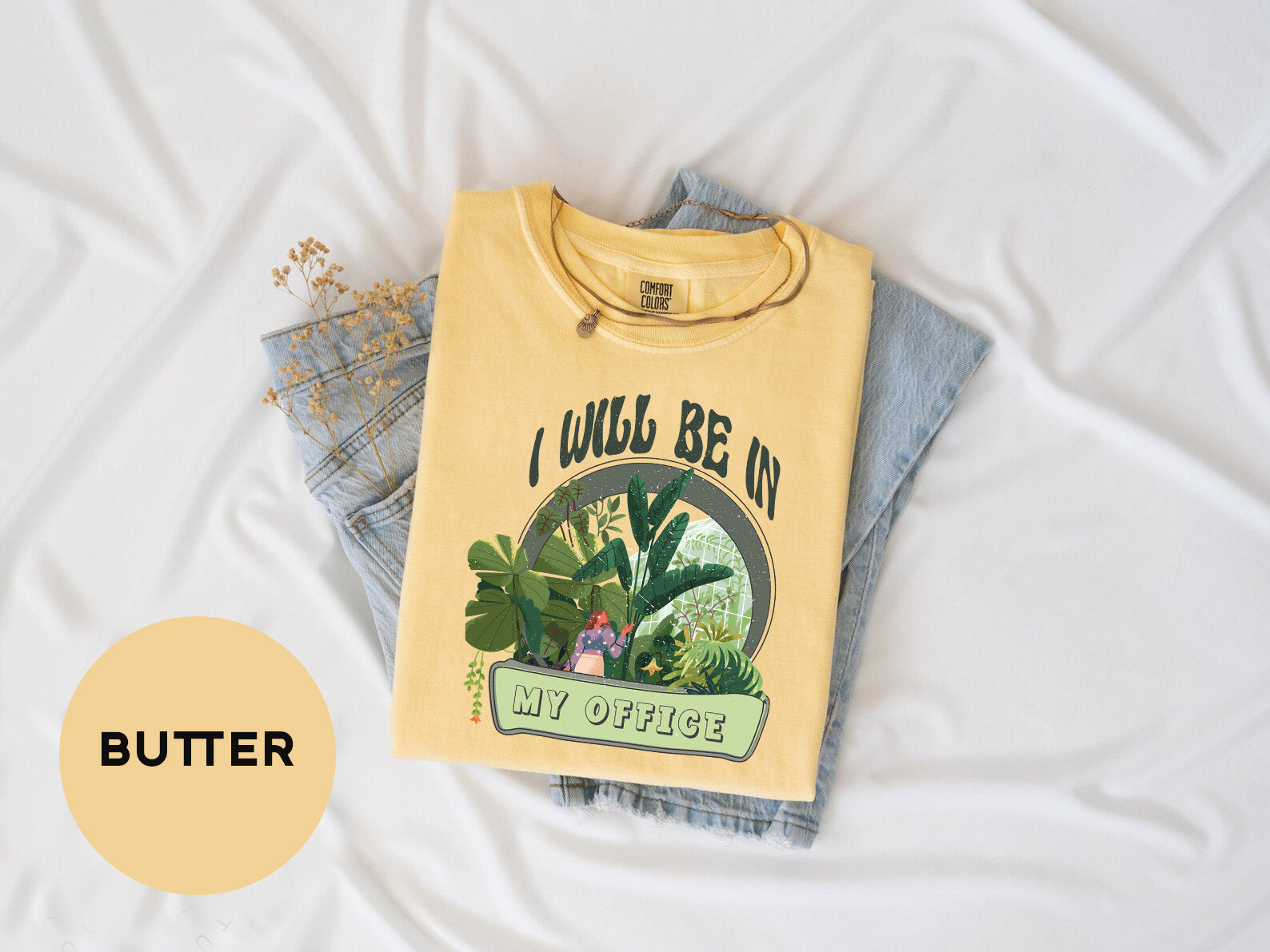 a yellow shirt with a picture of a plant on it