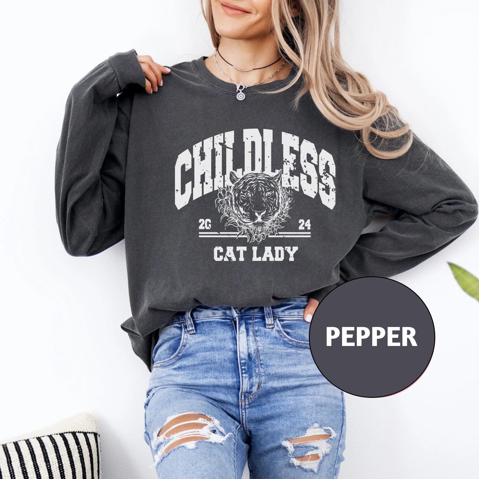 a woman wearing a black sweatshirt with a cat lady graphic on it