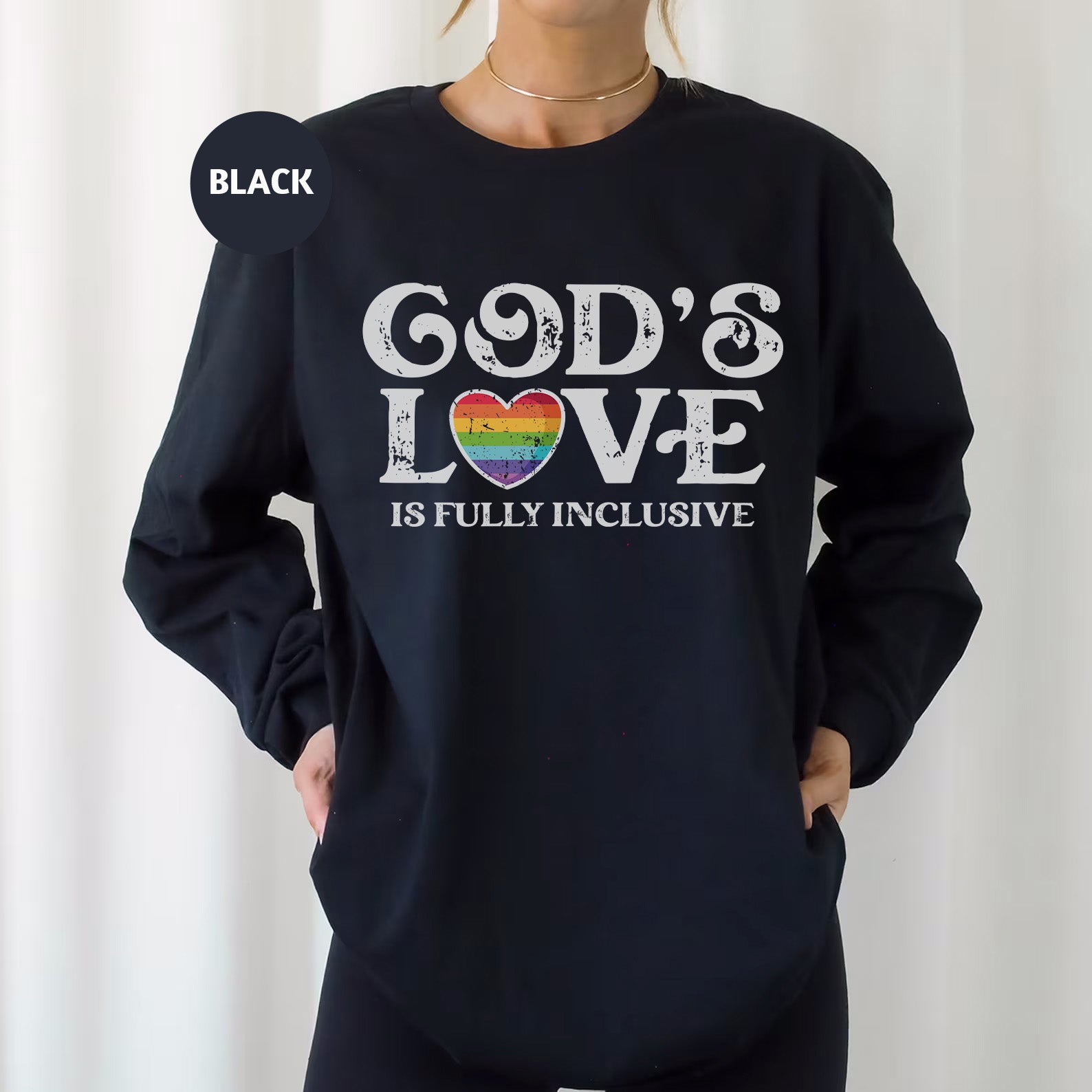 a woman wearing a black sweatshirt that says god's love is fully inclusive
