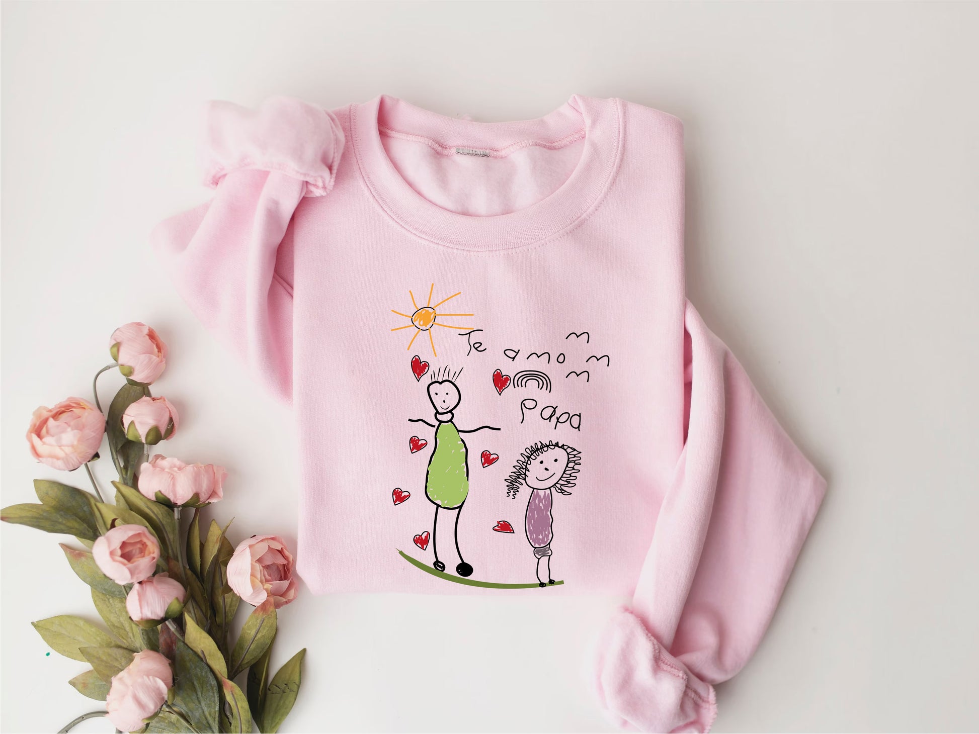a pink sweater with a drawing of a man and a woman