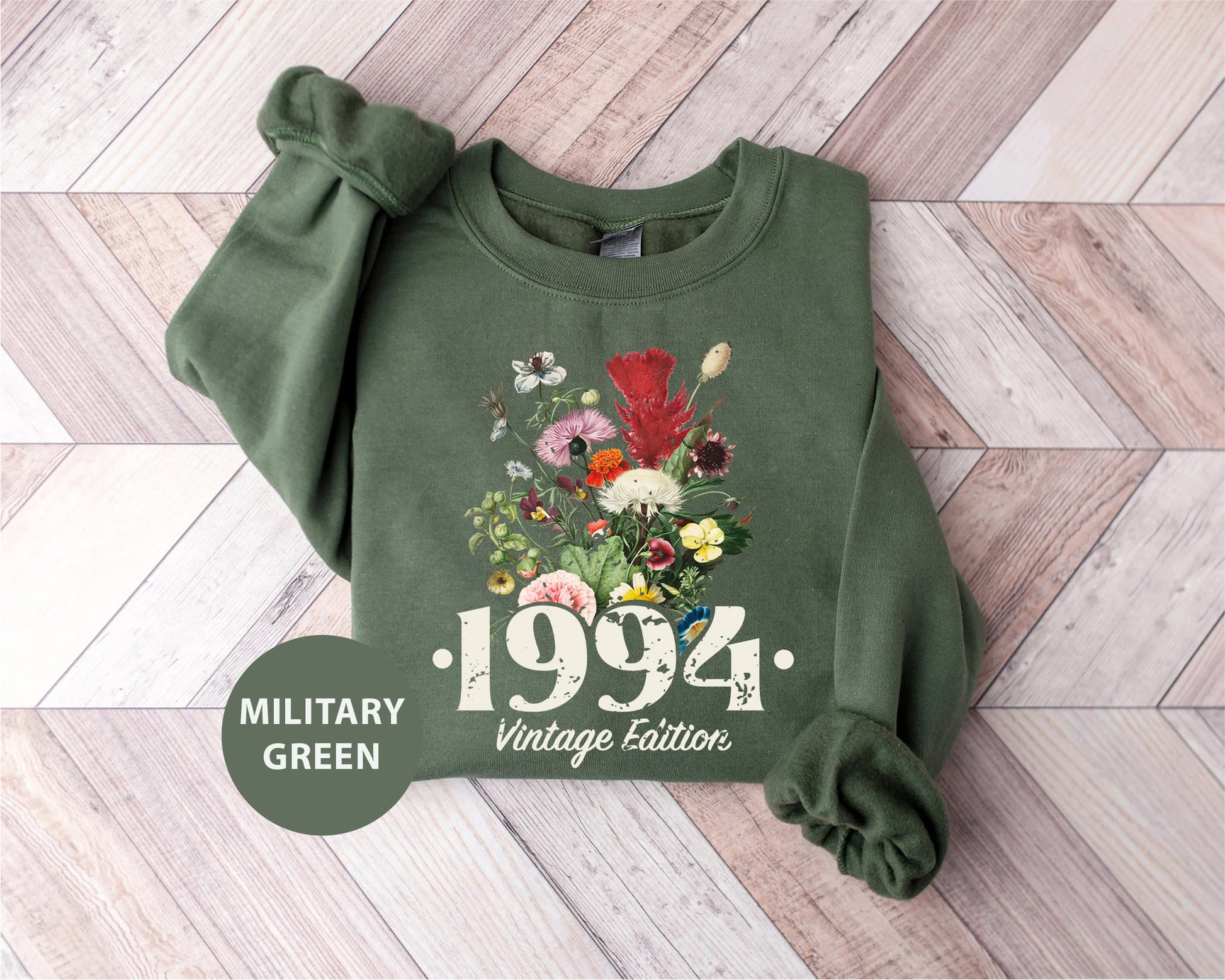 a green sweatshirt with a picture of flowers on it