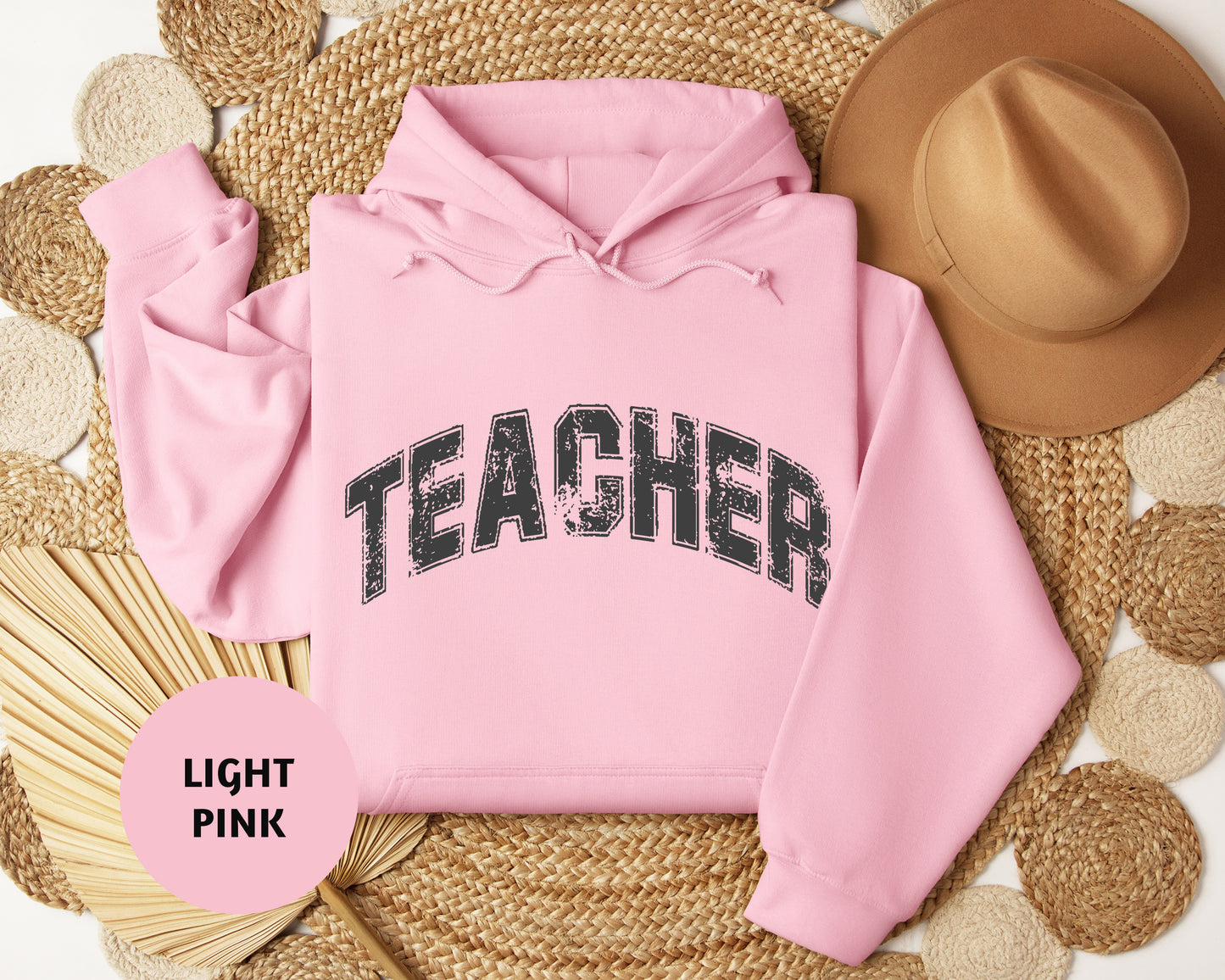 a pink hoodie with the word teacher printed on it