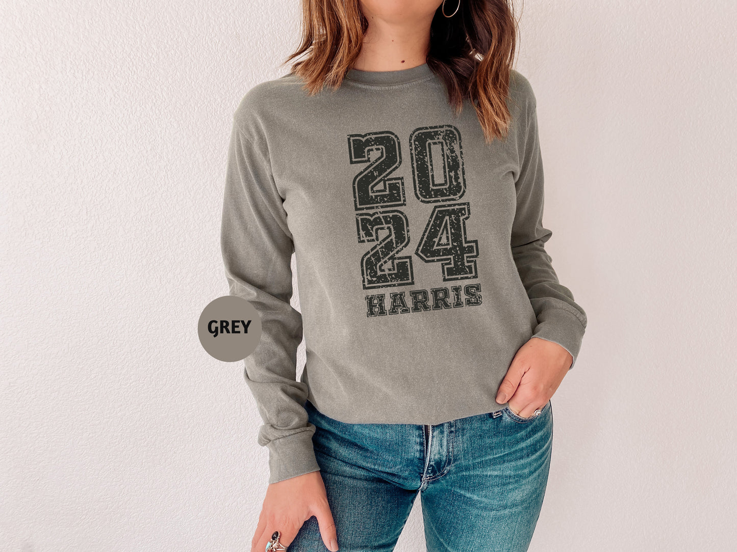 a woman wearing a gray sweatshirt and jeans