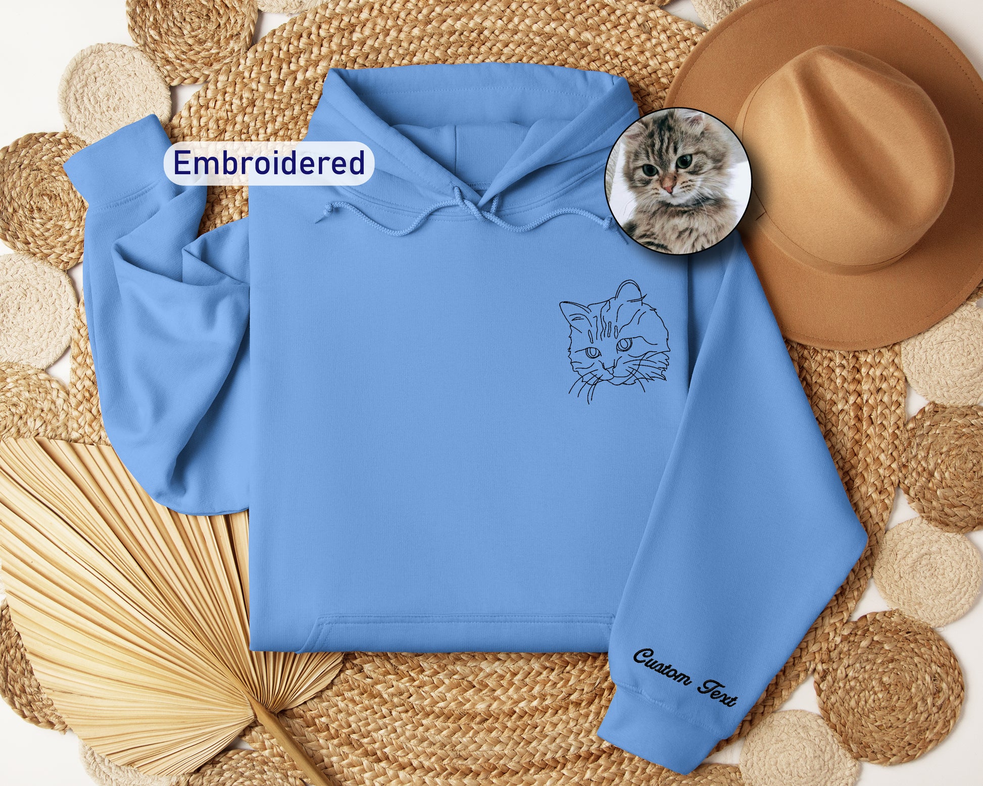 a blue hoodie with a picture of a cat on it