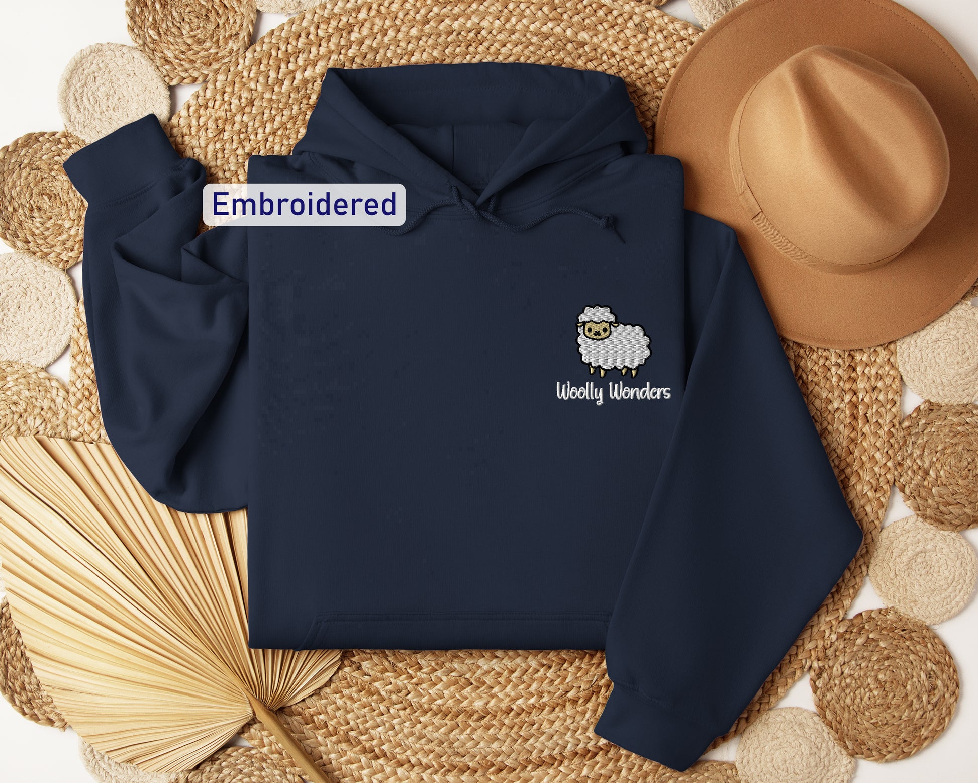 a blue hoodie with a sheep embroidered on it