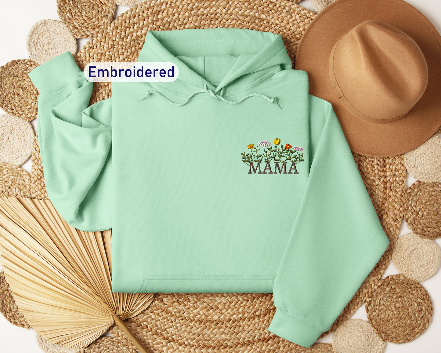 a green hoodie with embroidered mama on it