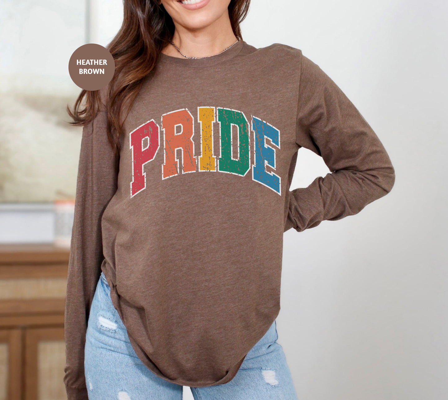 a woman wearing a brown shirt with the word pride on it
