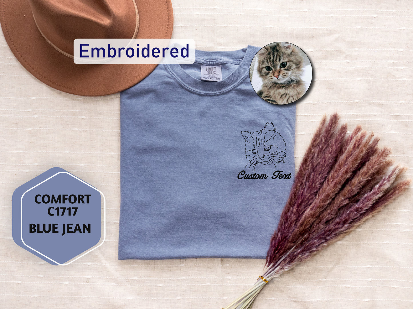 a t - shirt with a cat on it and a hat next to it