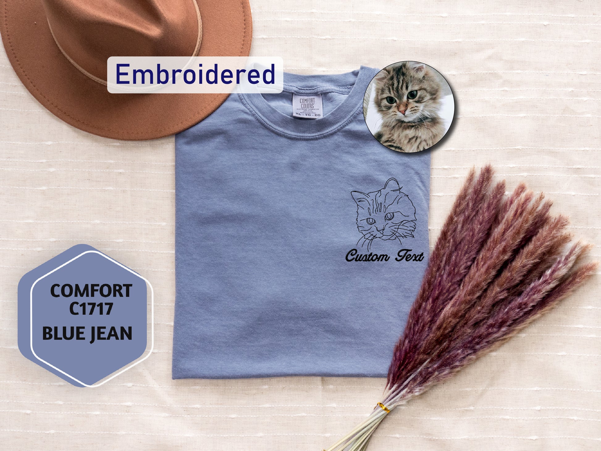 a t - shirt with a cat on it and a hat next to it