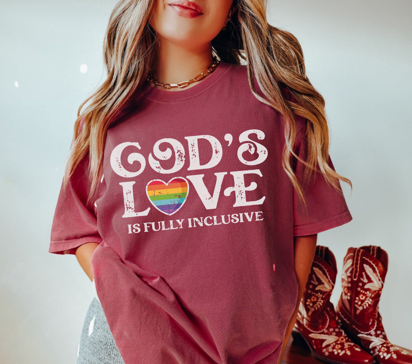 a woman wearing a t - shirt that says god's love is fully inclusive