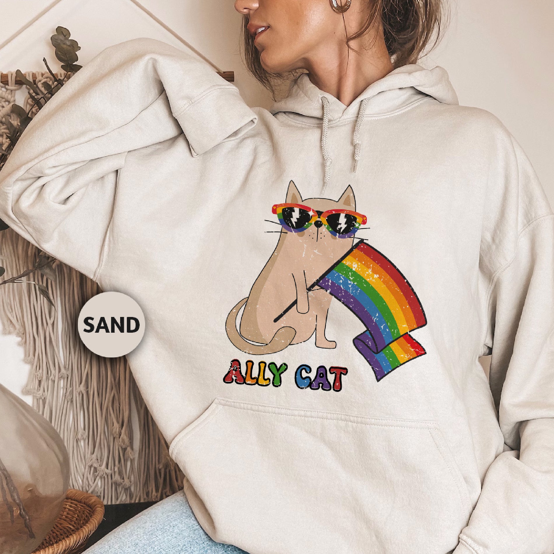 a woman wearing a white hoodie with a cat on it