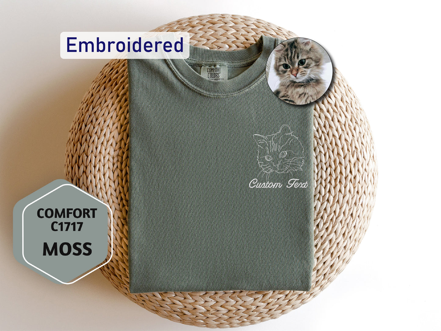 a cat laying on top of a green shirt