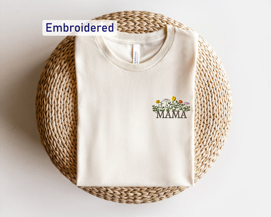 a white t - shirt with a flower embroidered on it