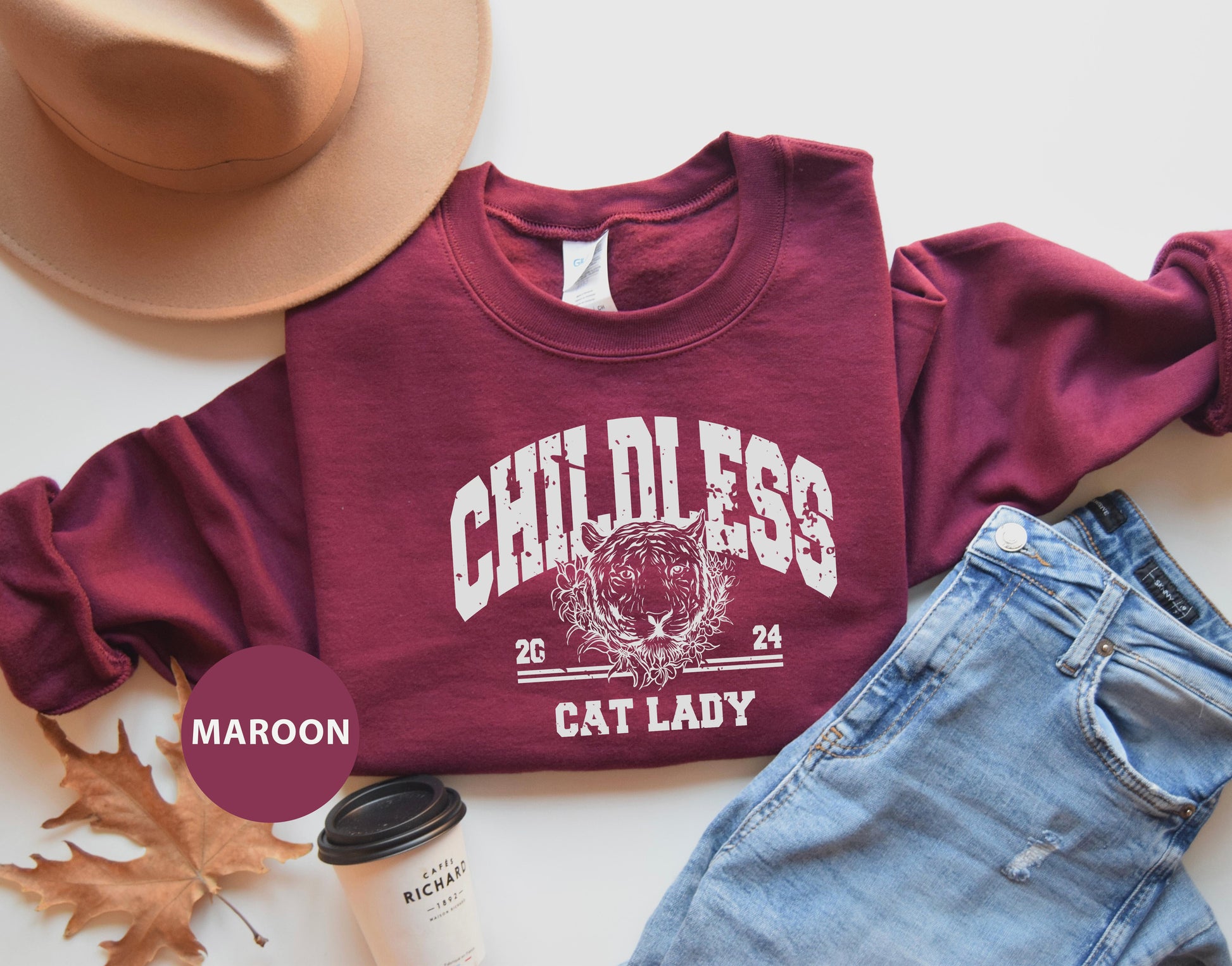 a maroon shirt with a cat lady on it