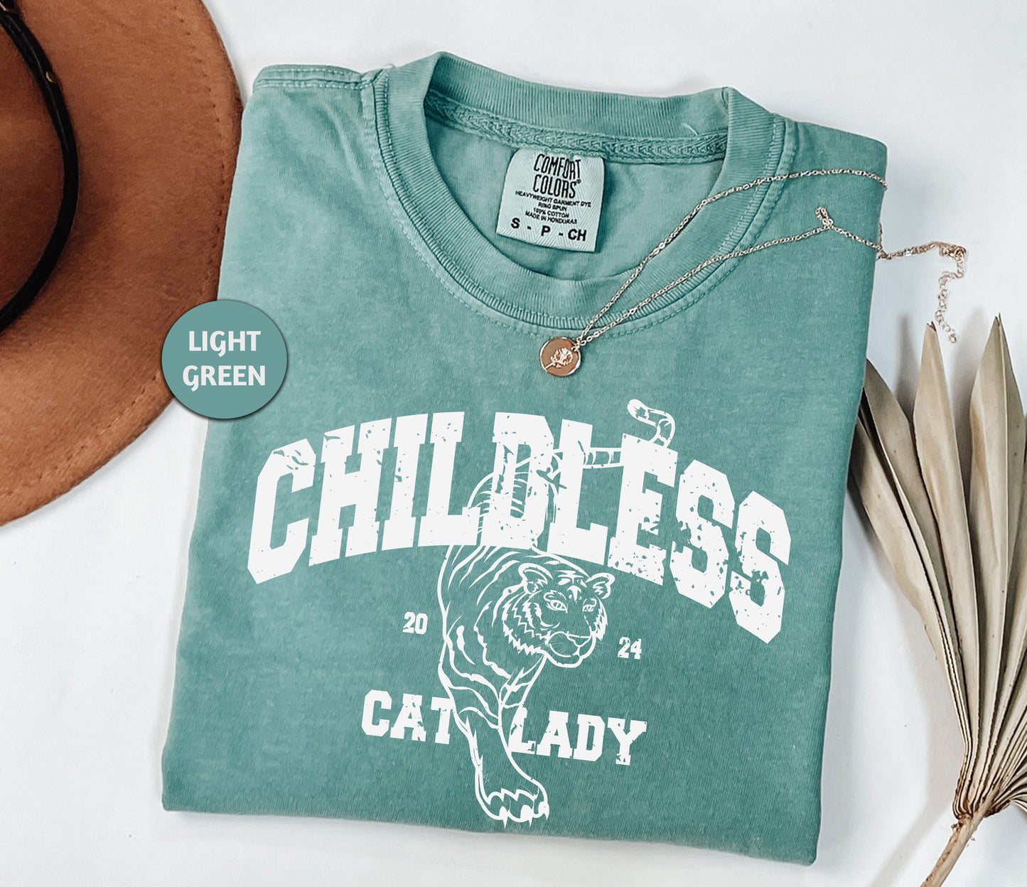 a green shirt with a cat lady on it