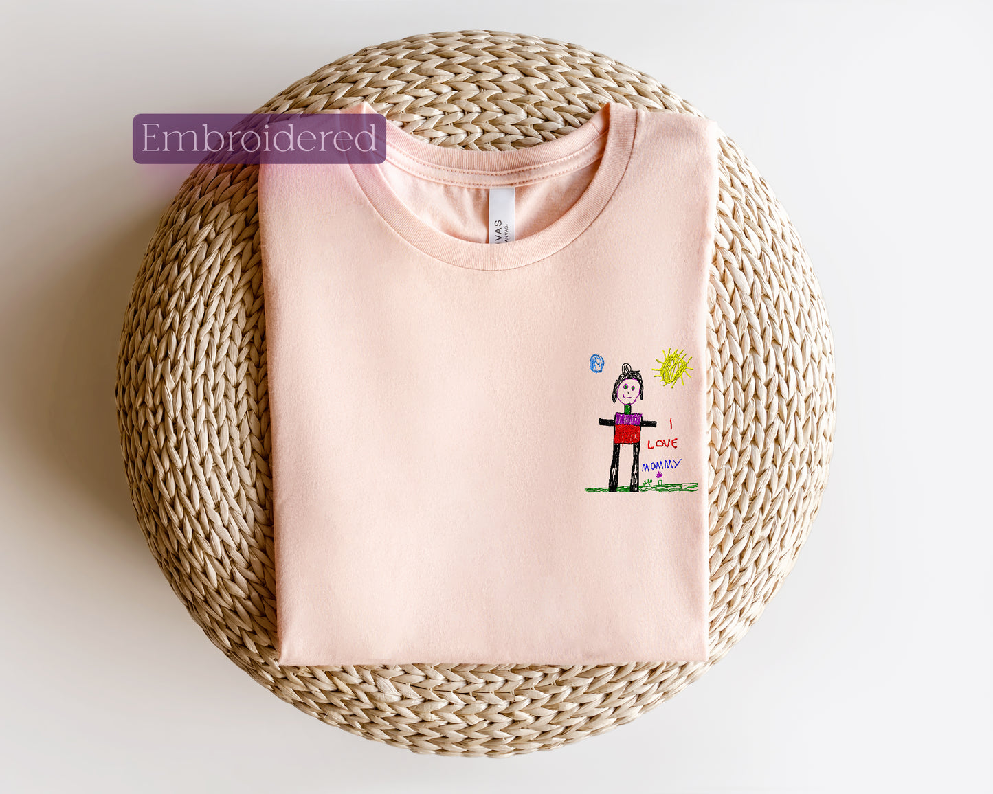 a pink t - shirt with a picture of a woman on it