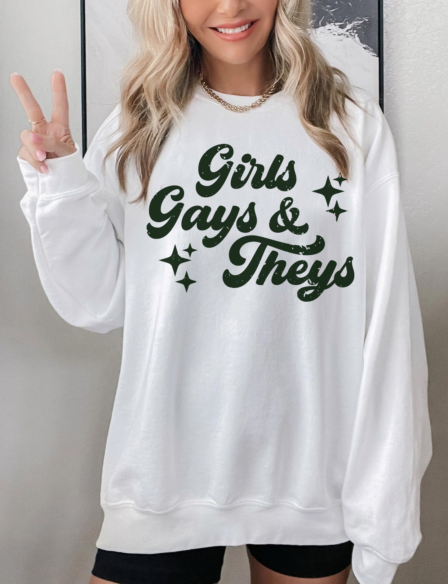 a woman wearing a white sweatshirt and black shorts