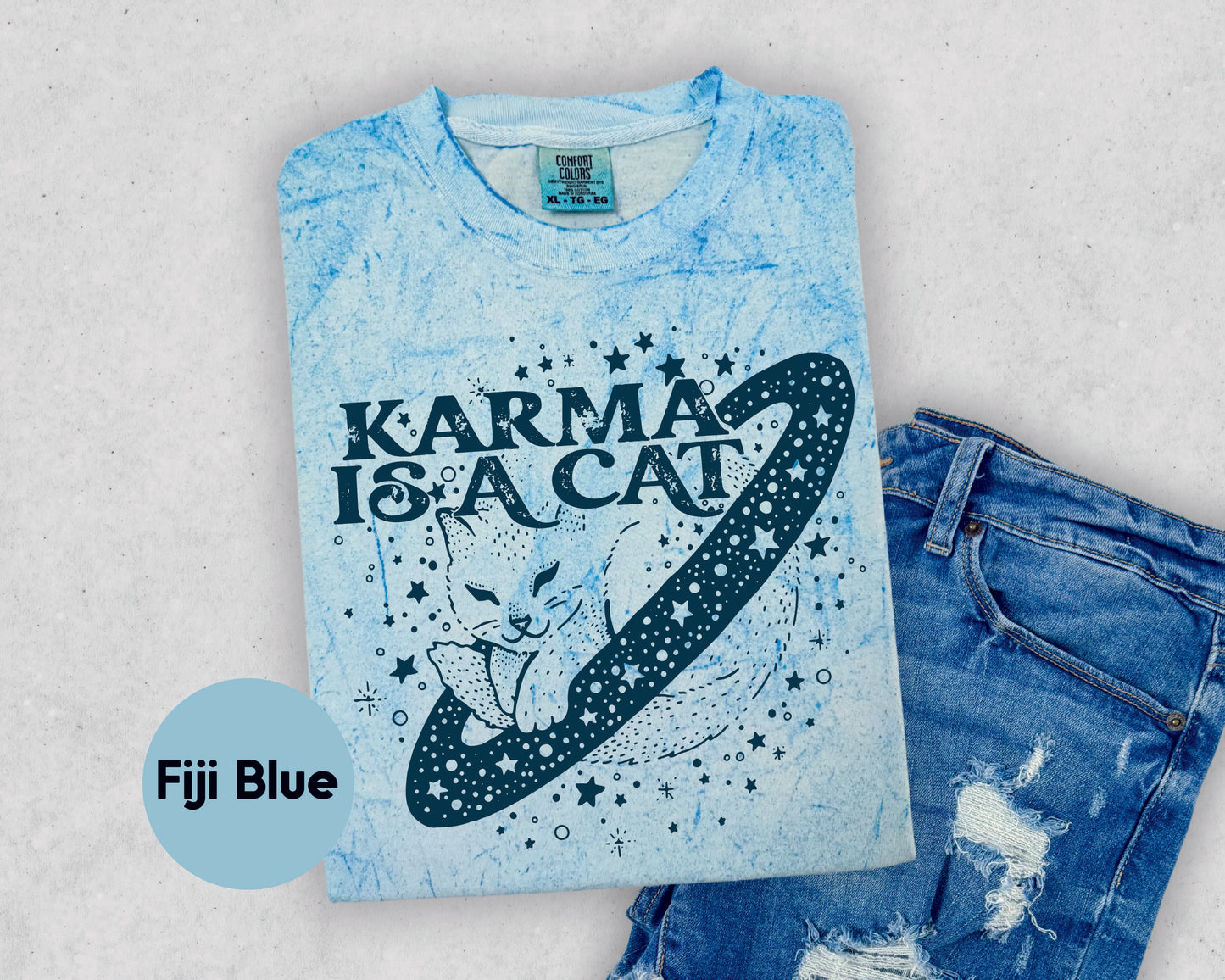 a t - shirt that says karma is a cat and a pair of ripped jeans