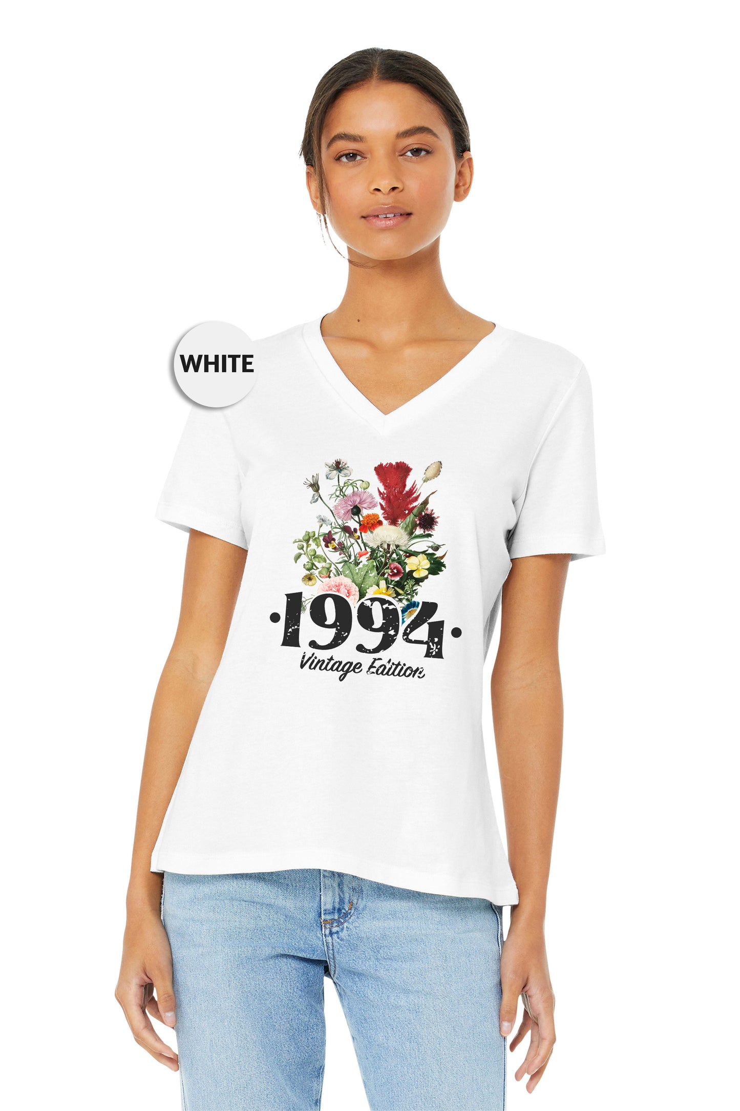 a woman wearing a white shirt with flowers on it