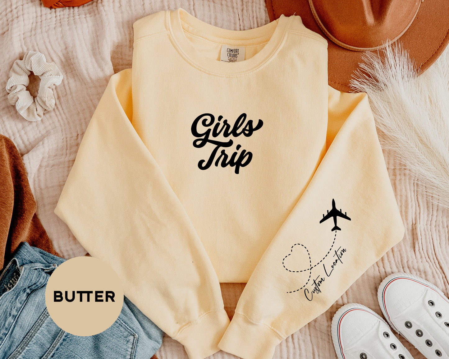 a pair of shoes and a sweater on a bed