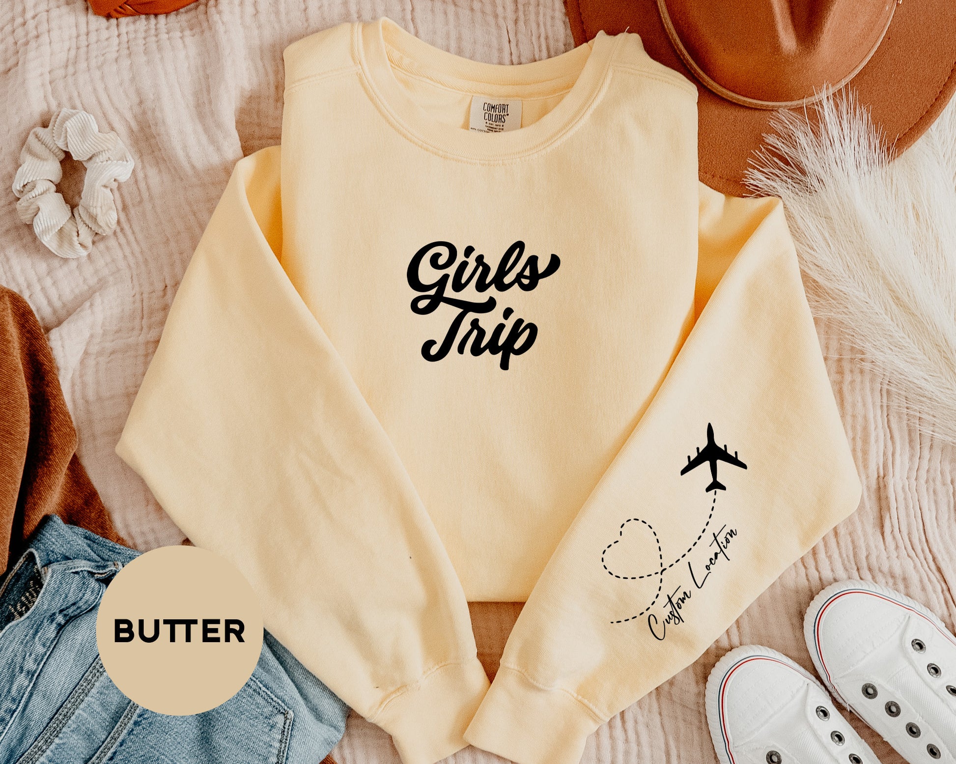 a pair of shoes and a sweater on a bed